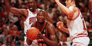 Chicago's Michael Jordan and Luc Longley defend Seattle's Shawn Kemp during game six of the NBA Finals in June 1996.