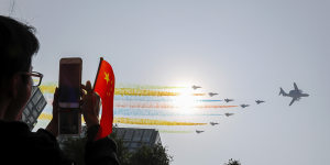 Chinese military planes fly in formation during a parade in Beijing to commemorate the 70th anniversary of the founding of communist China.