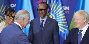 Prince Charles shakes hands with Prime Minister Boris Johnson,in front of Rwanda’s President Paul Kagame,before the CHOGM opening ceremony.