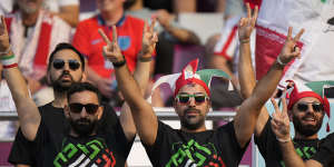 Iranian fans at the stadium make their own statements.