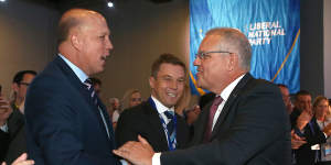 Prime Minister Scott Morrison pauses to shake hands with Home Affairs Peter Dutton at the QLD LNP convention.