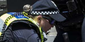 Police arrest a protester outside Flemington on Tuesday.