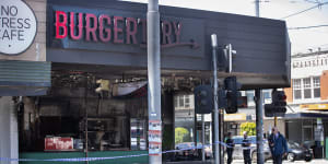 Victoria Police detectives at the scene of the destroyed Burgertory outlet.