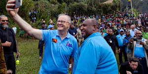 Prime ministers Anthony Albanese and James Marape take a selfie after the Anzac Day dawn service at the Isurava memorial site on the Kokoda Track in PNG.