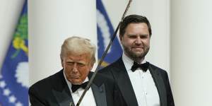 Donald Trump holds a sabre after using it to cut a cake,as Vice President J.D. Vance looks on,at the Commander-in-Chief Ball,part of the 60th Presidential Inauguration. 