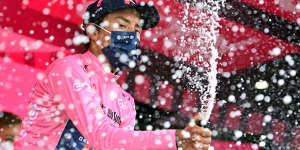 Egan Bernal celebrates after retaining the pink jersey on the 20th stage.