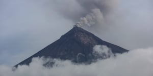 A plume of smoke and ash rise from the Volcano of Fire as seen from San Miguel Los Lotes,Guatemala,in June.