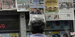 A man reads the headlines announcing the results of the Brazilian presidential election,in Rio de Janeiro.