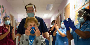 Margaret Keenan is applauded by staff as she returns to her ward after becoming the first person in the United Kingdom to receive the Pfizer/BioNtech vaccine.