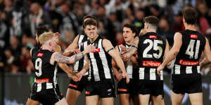 Josh Carmichael is congratulated by Magpies teammates after a goal.