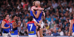 Max Gawn celebrates a goal with his teammates.