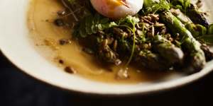 Asparagus with poached egg and toasted seeds.