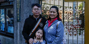 Alex Chan with his wife and his daughter outside a polling station in Taipei. 