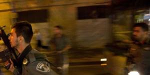 Israeli policemen run looking for a possible stabbing suspect in Jerusalem on Wednesday.