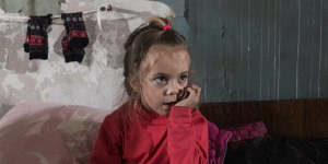 A girl sits in an improvised bomb shelter in Mariupol,Ukraine.