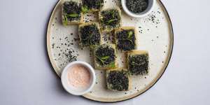 Tofu with black sesame seeds.
