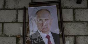 A smashed portrait of Russian President Vladimir Putin lies outside a police prison used to hold and torture Ukrainian prisoners by Russian forces in Kherson.