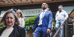 Wallabies star Kurtley Beale with supporters and lawyers outside court on Tuesday.