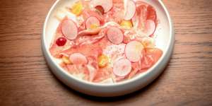 Culatello with gapes and radish slices.
