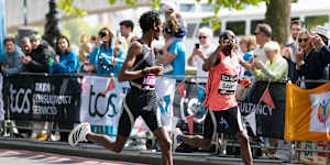 Yomif Kejelcha and Sabastian Sawe during the London Marathon. Sawe is drinking from a Maurten bottle.