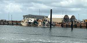 A vessel tipped on its side at Exmouth marina.
