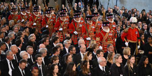The Yeomen of the Guard march into Westminster Hall ahead of the King.