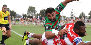 Alex Johnston denies Dragons winger Mikaele Ravalawa a try in the corner on Saturday.