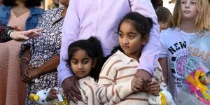 Sisters Kopika,right,and Tharnicaa with their parents Priya and Nades Murugappan at a press conference after they landed at the Thangool Aerodrome near Biloela on Friday.