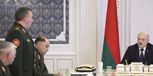 Belarusian President Alexander Lukashenko (right) attends a meeting with military top officials in Minsk.