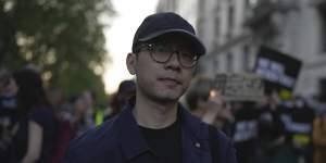 Hong Kong activist Nathan Law attends a candlelight vigil outside the Chinese embassy in London.