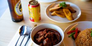 Jollof rice,goat stew and fried plantains.