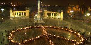 Thousands of people bearing torches form a giant peace sign on Budapest’s Hero’s Square in 2004 to protest the war in Iraq.