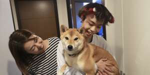 Wataru Yoshida at home with his mother,Kae Yoshida,and their dog,in Tokyo.
