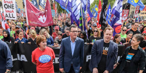 Lisa Fitzpatrick from the ANMF,Premier Daniel Andrews,Luke Hilakari from Trades Hall and ACTU secretary Sally McManus march together in Melbourne in 2018.