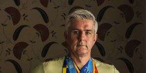 Joseph Moran wears the medals from every major marathon he has won.