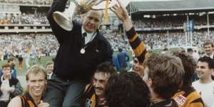 Premiership coach Allan Jeans holds up the cup.