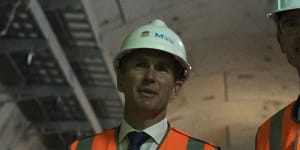 Infrastructure Minister Rob Stokes,left,and Premier Dominic Perrottet inspect a new rail tunnel late last year.