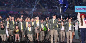 Eddie Ockenden and Rachael Grinham,flag bearers of Team Australia lead their team out during the opening ceremony of the Commonwealth Games wearing uniforms by RM Williams.