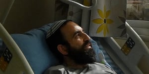 Rabbi Shachar Butzchak being treated in the Soroka Medical Centre for bullet wounds in his leg after being shot during the Hamas attack in Ofakim,Israel.