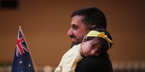 Vikas Gadoo,with one-year-old daughter Tiana,became an Australian citizen at Melbourne Town Hall on Thursday.