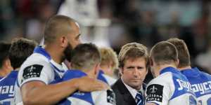 Des Hasler consoles the players after the heartache of the 2012 grand final loss to Melbourne.