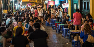 Tourists enjoying night life at Bia Hoi Beer Bars in the old quarter of Hanoi.