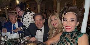 Gina Rinehart talks to US President Donald Trump during a Halloween party at Mar-a-Lago,as Secretary of State Marco Rubio poses in the foreground.
