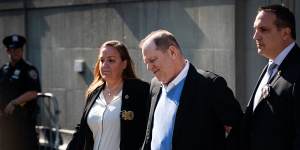 Harvey Weinstein being escorted in handcuffs out of the New York Police Department.