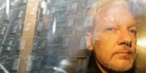 Julian Assange being taken from court last year.
