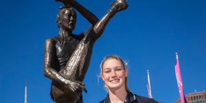 Tayla Harris unveils a prototype of her upcoming bronze statue at Federation Square in 2019.