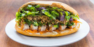Pork belly banh mi with red curry paste,crunchy chilli oil and plenty of herbs.