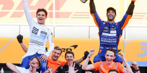Lando Norris and Daniel Ricciardo celebrate with the McLaren crew.