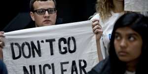 A demonstrator holds a"Don't Go Nuclear"sign on Capitol Hill in Washington,DC. 