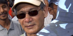 Police escort convicted French serial killer Charles Sobhraj from court in Katmandu in 2004.